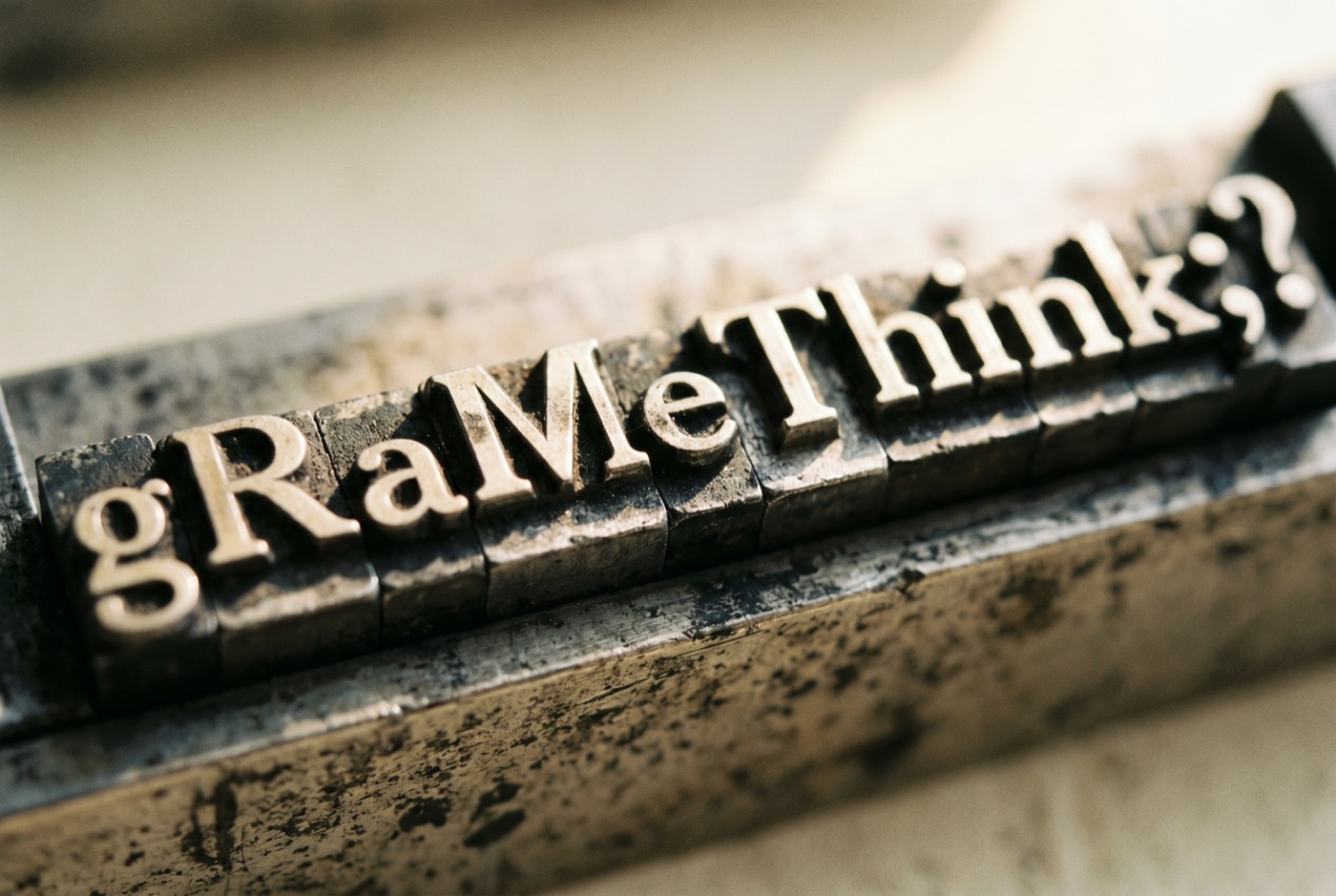Macro shot of lead printer type blocks arranged in a composing stick